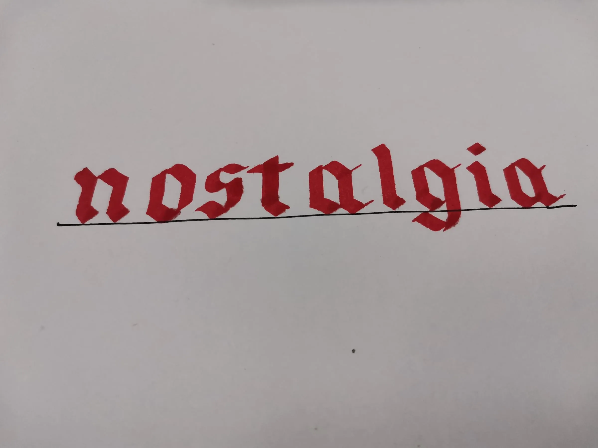 The word nostalgia written in red blackletter