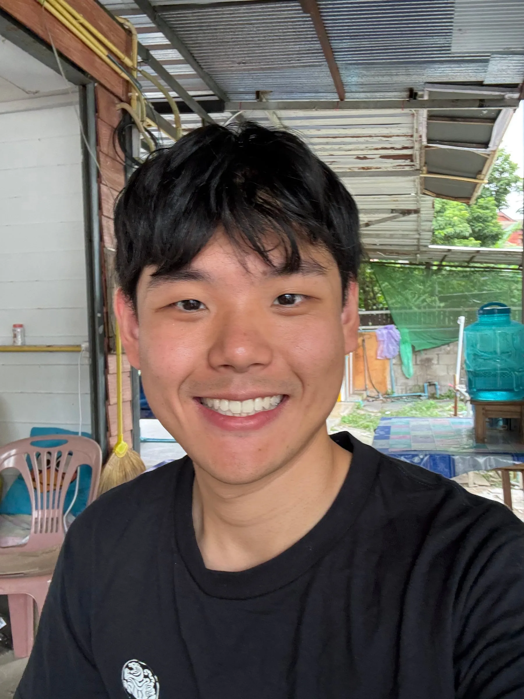 Close-up selfie of Alan smiling at an outdoor market