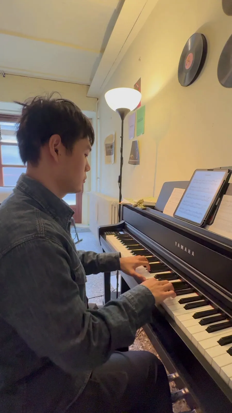 Alan playing a Yamaha upright piano