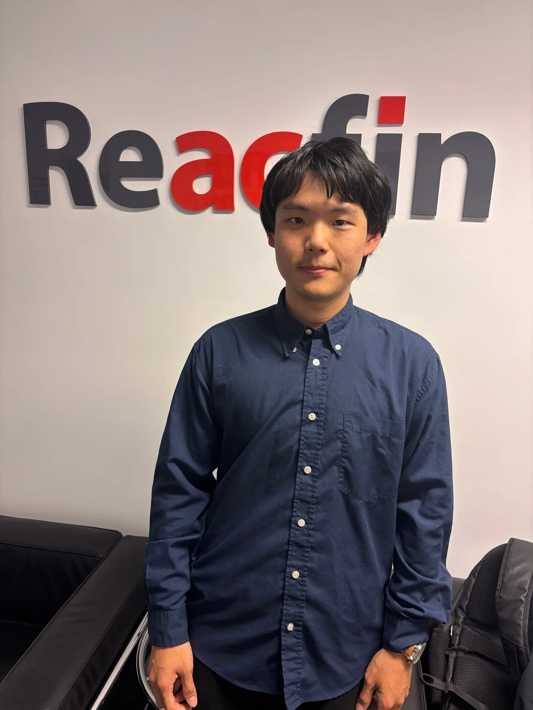Alan standing in front of the Reacfin logo